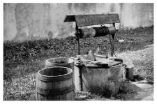 A well with a winch, barrels