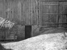 An entrance to a stable under a barn