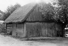 A half-log, half-timbered barn