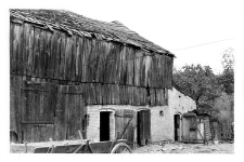 A barn with a brick cow-shed