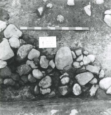 Stones concentration not bonded with any mortar (layer 18) in south-western corner of a plot